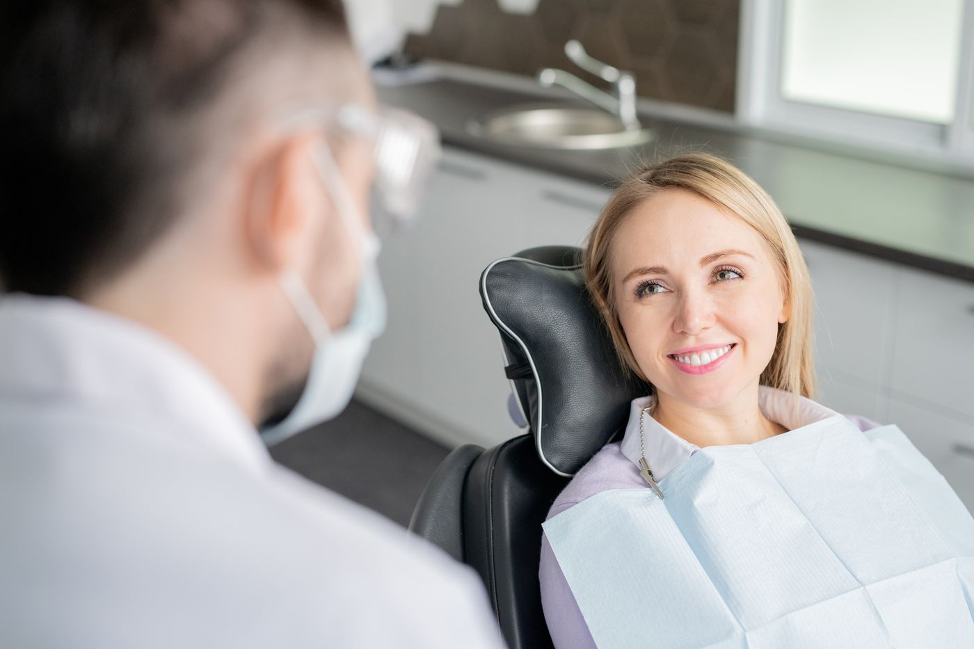 Dentist and patient in dental office during consultation