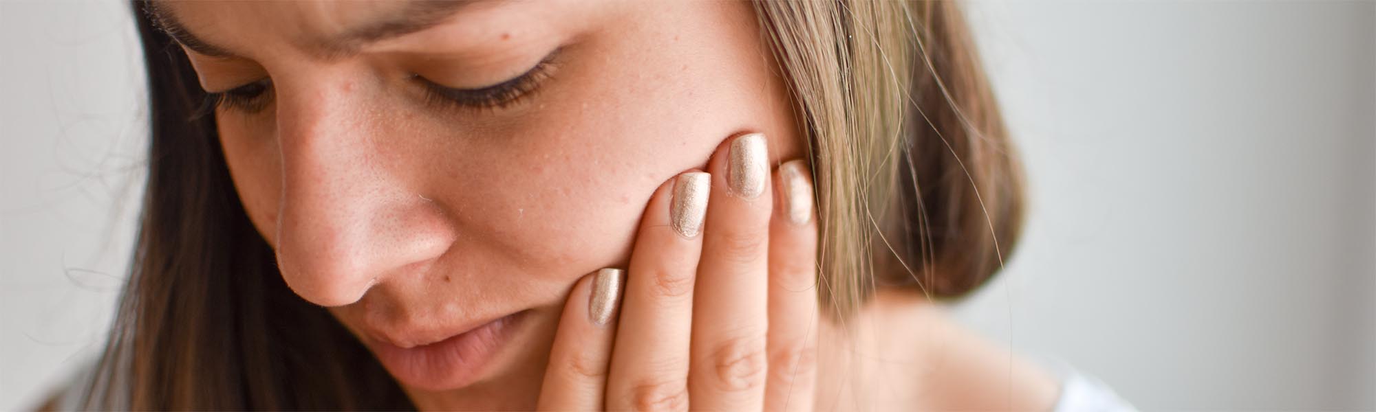 Woman holding her jaw from sore gums, periodontal disease Torrance CA